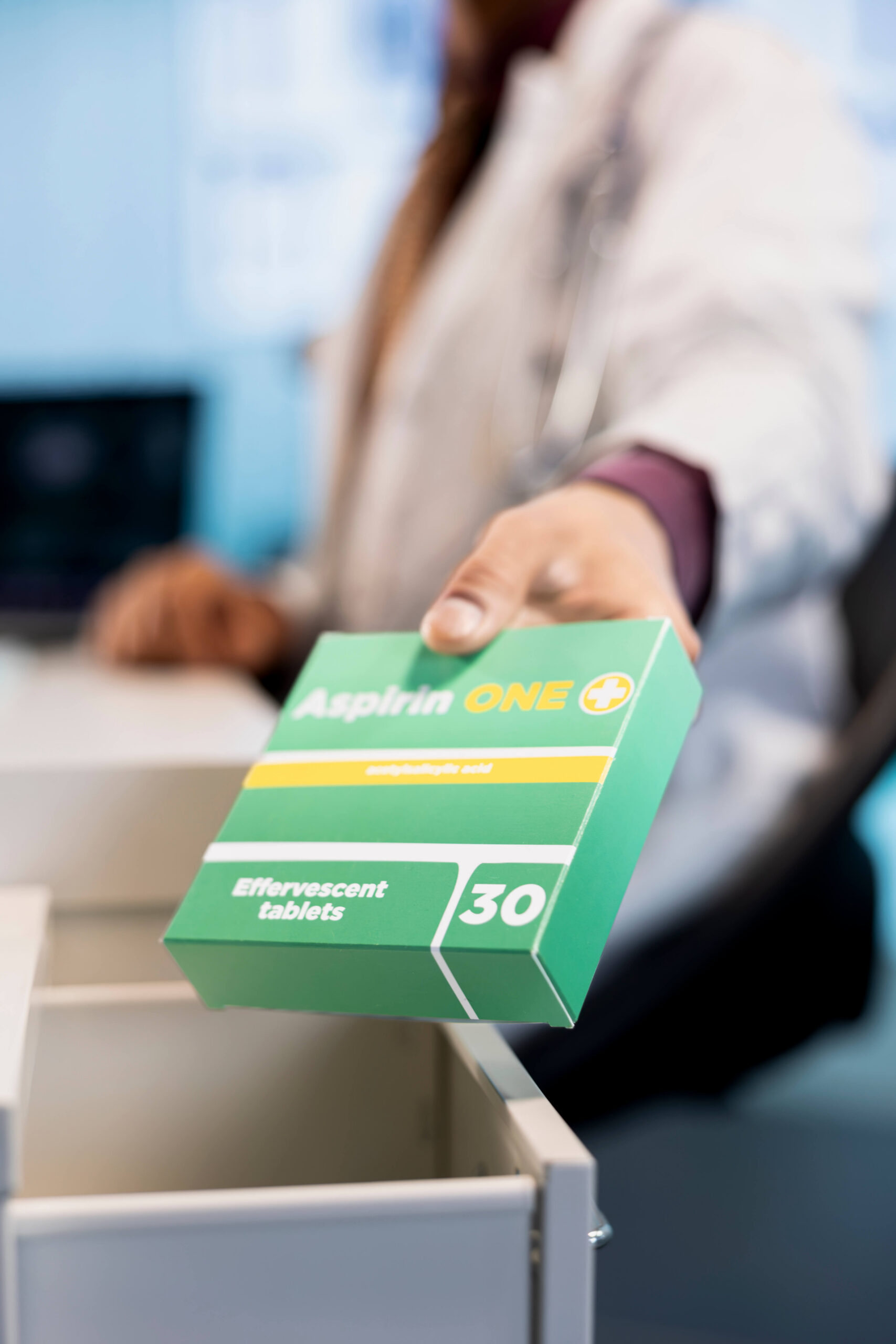 mano di un farmacista che prende medicine da un cassetto